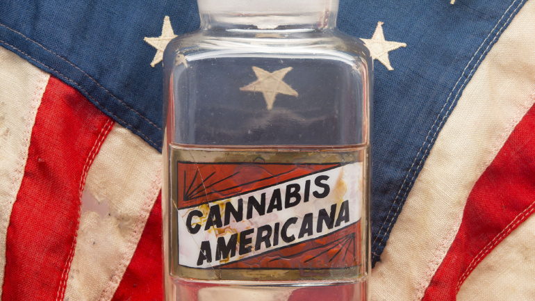 Cannabis Americana Image of Glass Container with American Flag Background